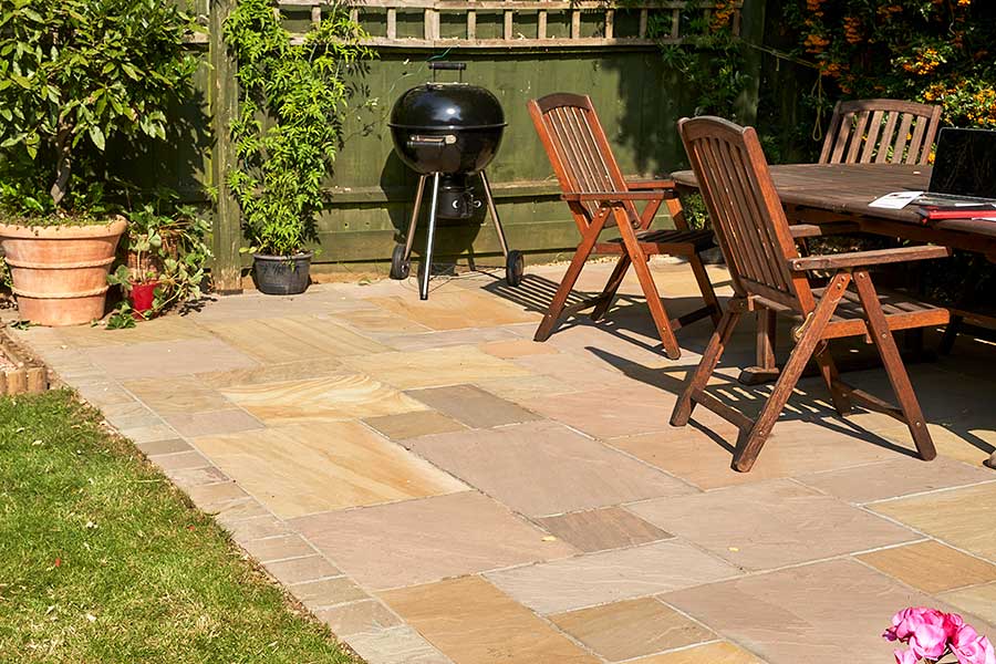Stylish patio featuring Global Stone Country Buff Indian Sandstone paving